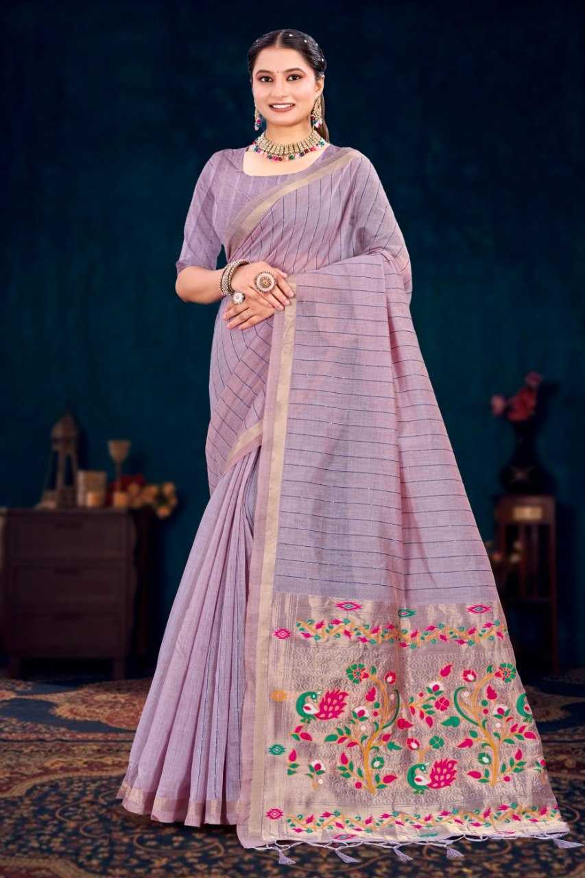 Woman wearing a light purple saree with floral embroidery on a dark background