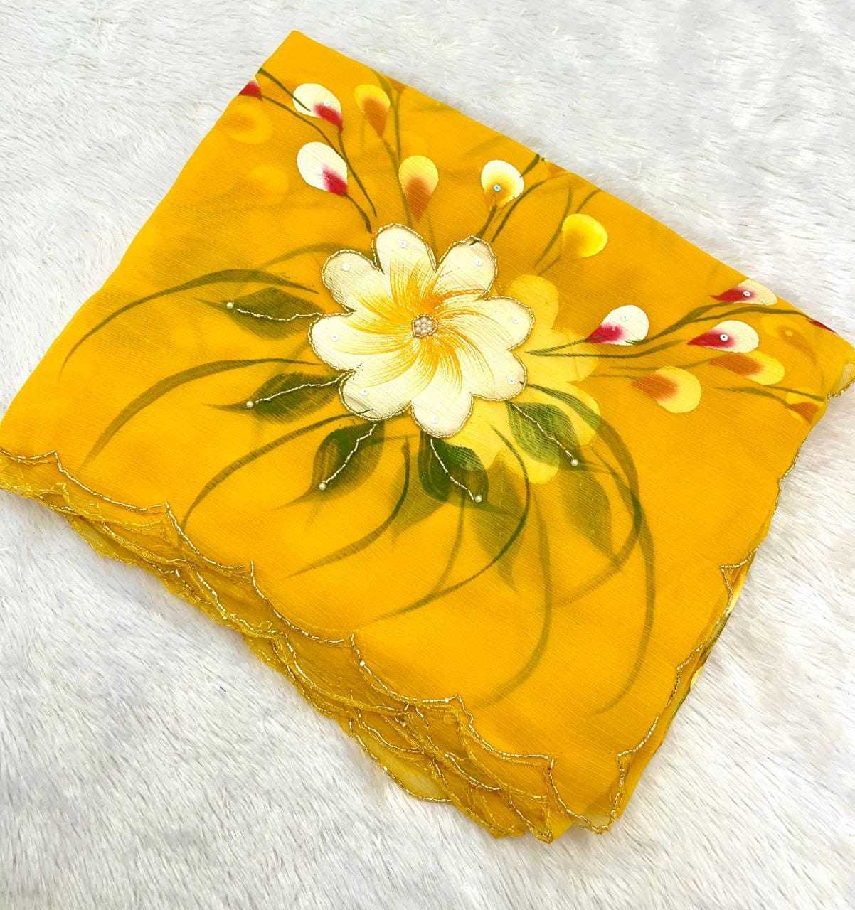 A square yellow scarf with scalloped edges, featuring a hand-painted style white flower with green leaves and yellow buds, laid flat on a white textured background.