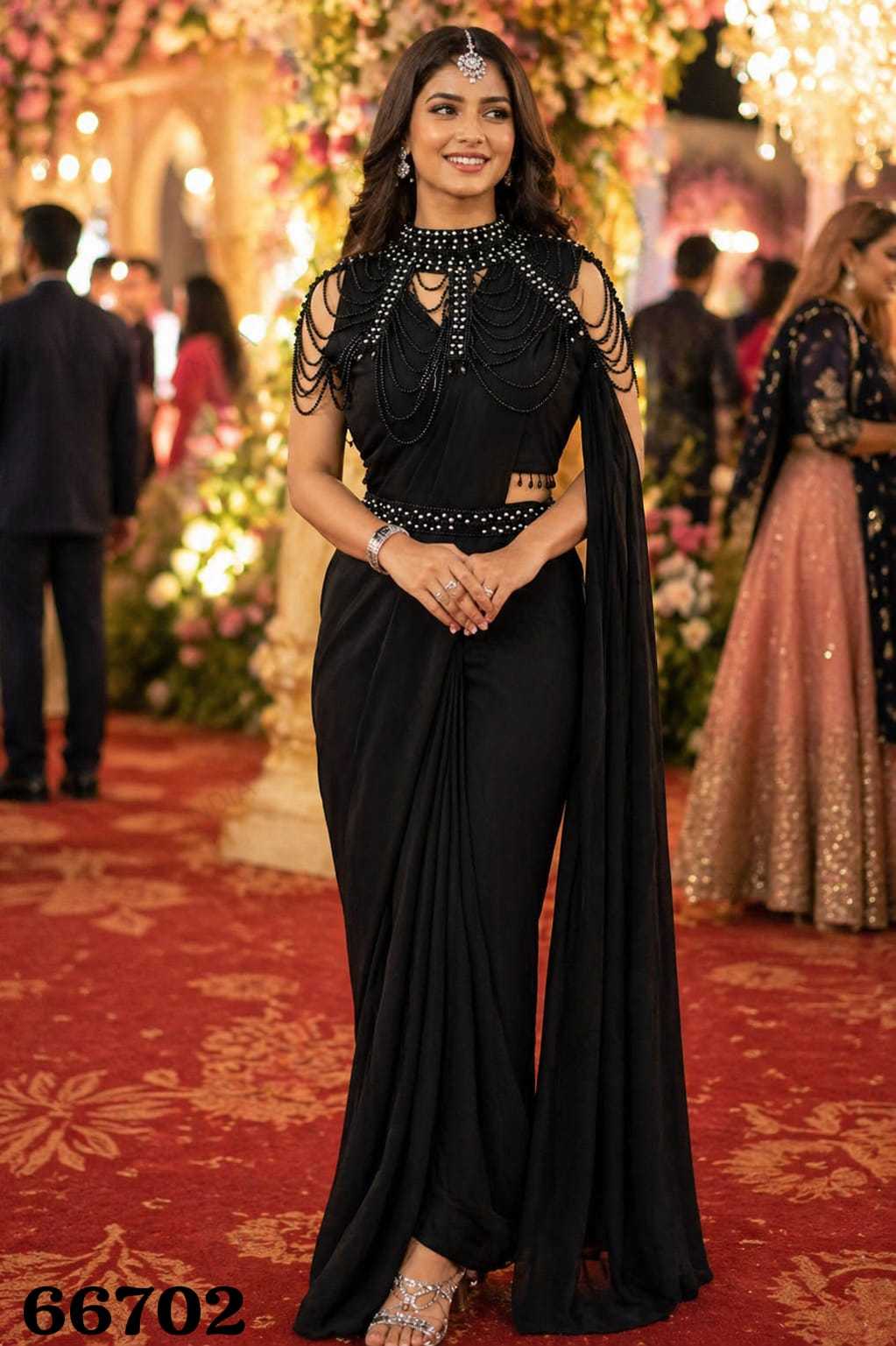 Woman in a black saree with embellishments at an event