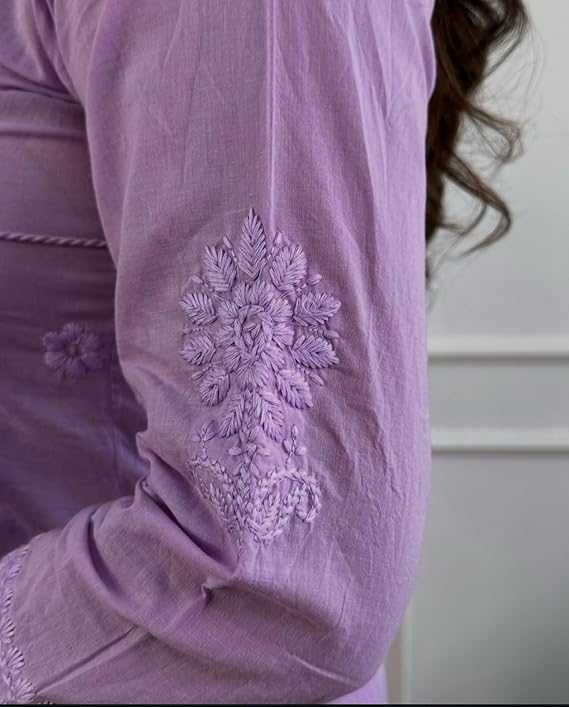 Close-up of a lavender garment with intricate floral embroidery on a plain background