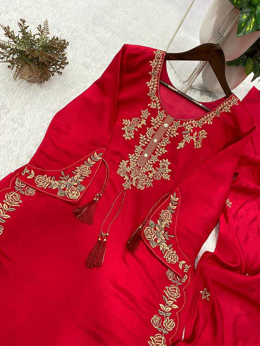 Red garment with gold embroidery on a white surface
