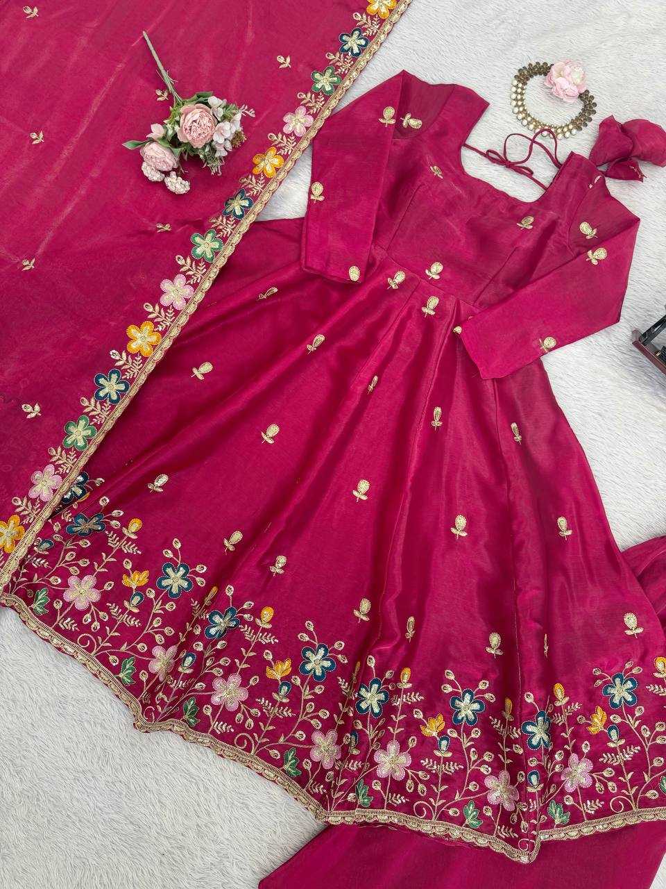 Pink saree with floral embroidery on a white background