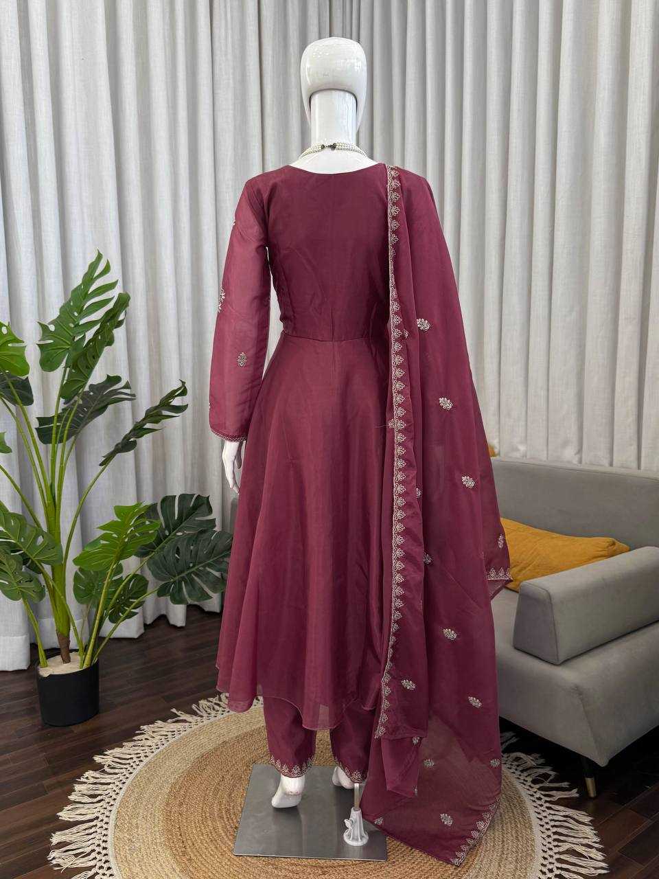 Maroon traditional outfit with a dupatta on a mannequin against a neutral background