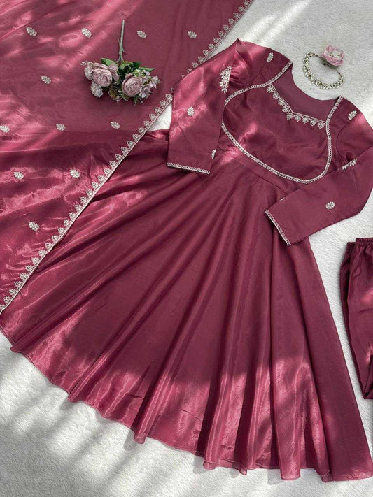 Maroon traditional outfit with matching saree and blouse on a light background