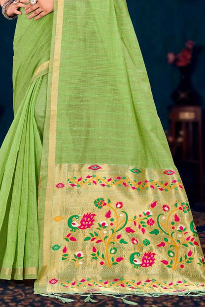 Green saree with floral embroidery on a dark background
