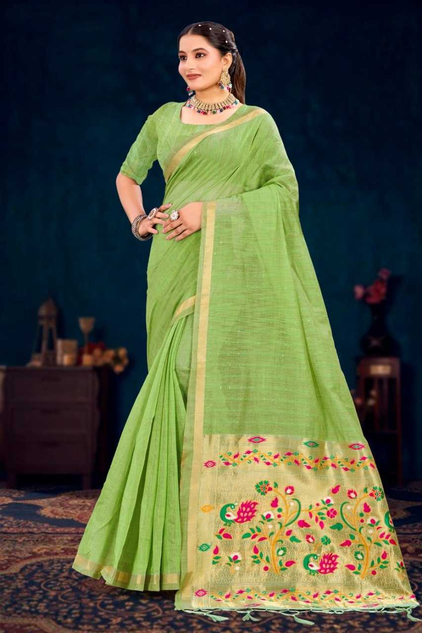 Woman wearing a green saree with floral patterns against a dark background