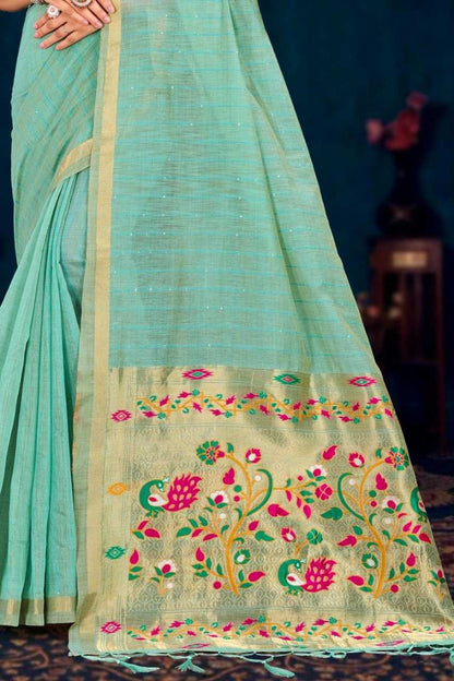 Light blue saree with floral embroidery on a dark background