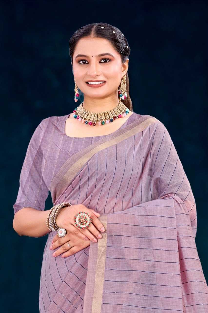 Woman in a traditional saree with jewelry against a dark background