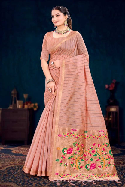 Woman wearing a traditional saree with floral patterns against a dark background