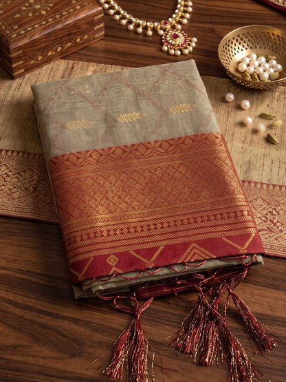 Traditional saree with intricate patterns on a wooden surface