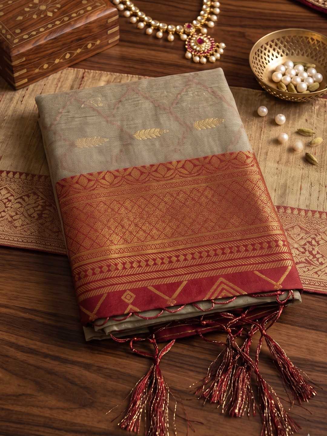 Traditional saree with intricate patterns on a wooden surface