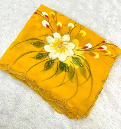 A square yellow scarf with scalloped edges, featuring a hand-painted style white flower with green leaves and yellow buds, laid flat on a white textured background.