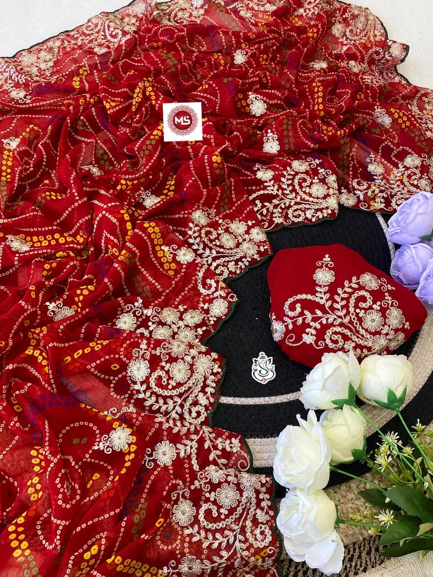 Red embroidered fabric with a white logo tag, black fabric with white embroidery, and flowers on a white background.