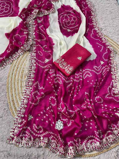 Pink embroidered fabric with white patterns on a gray surface
