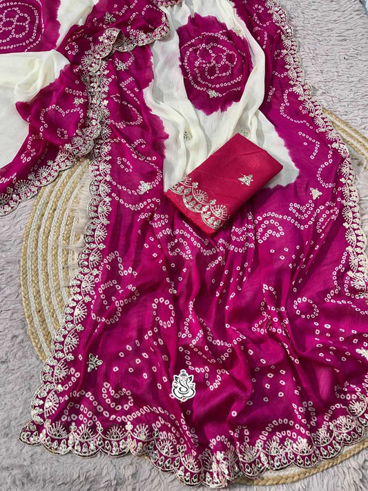 Pink embroidered fabric with white patterns on a gray surface