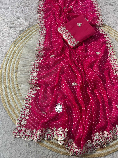 Red saree with white patterns on a textured surface