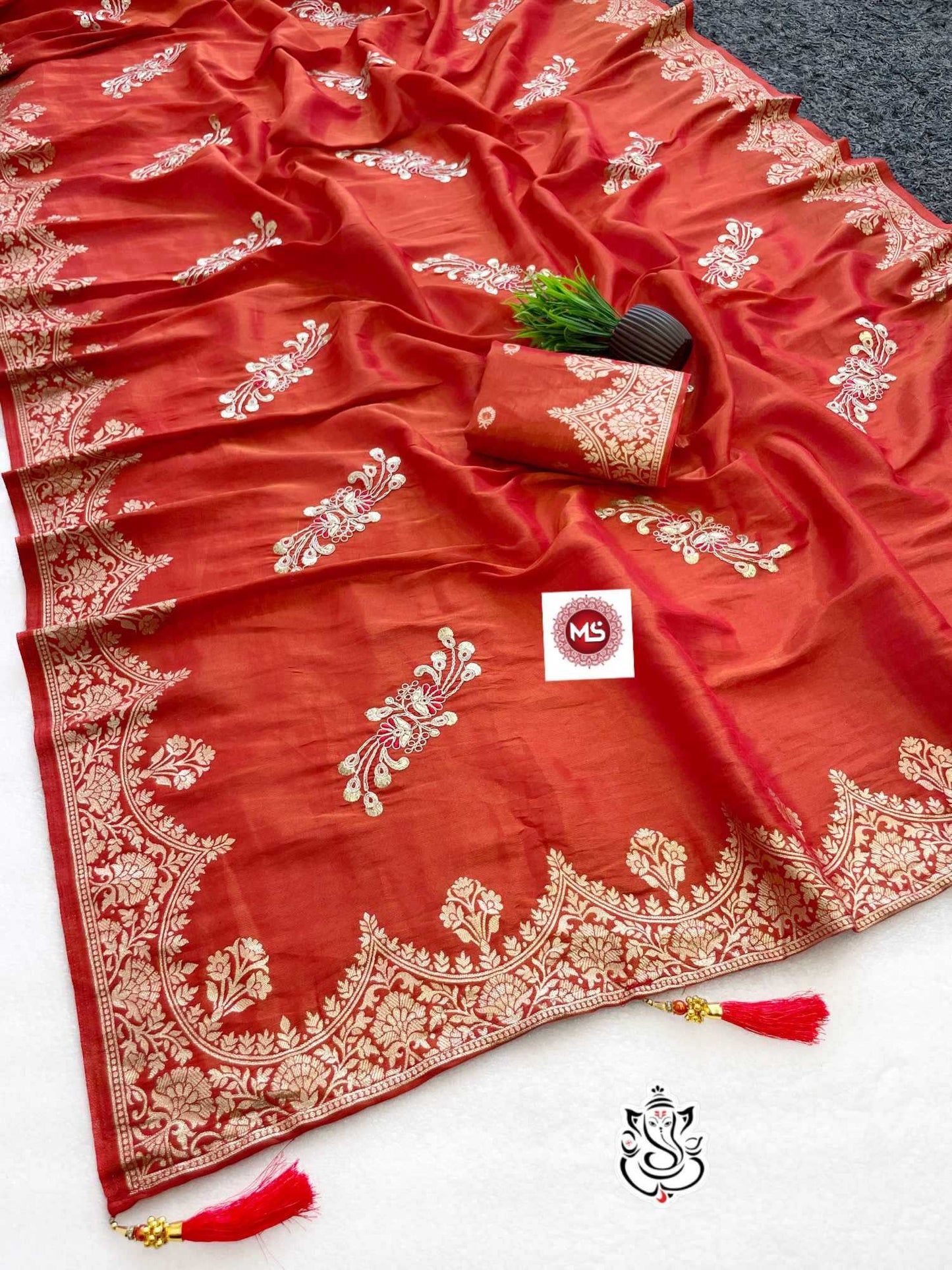 Red saree with white embroidery on a white background