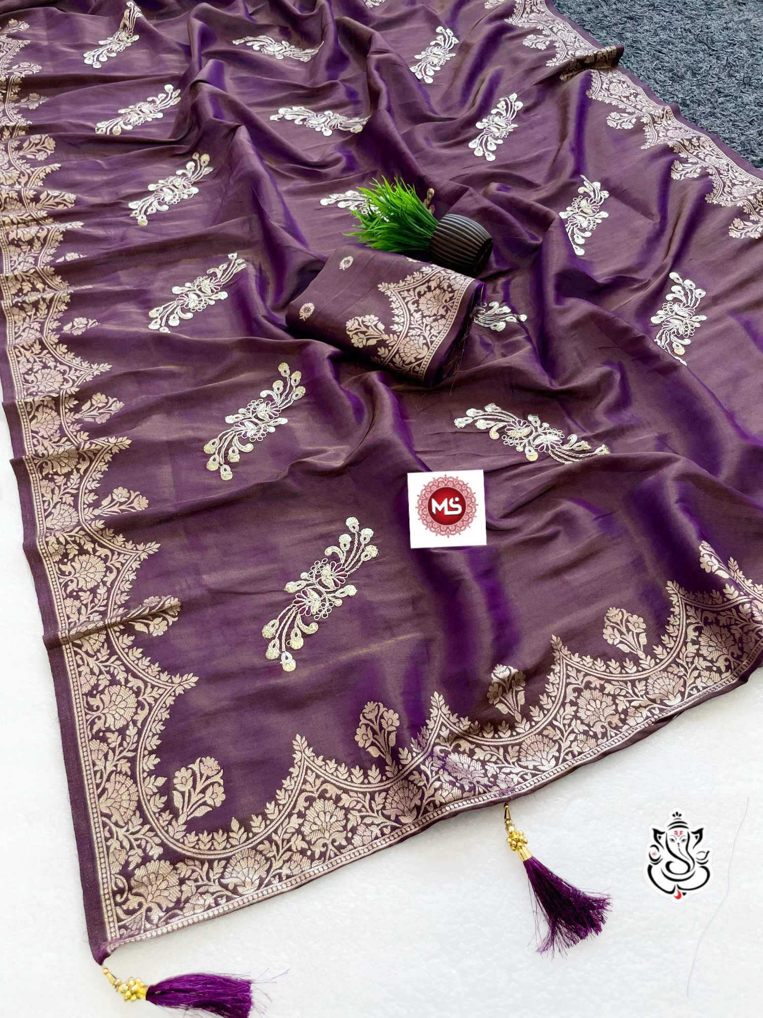 Purple saree with white embroidery on a white background