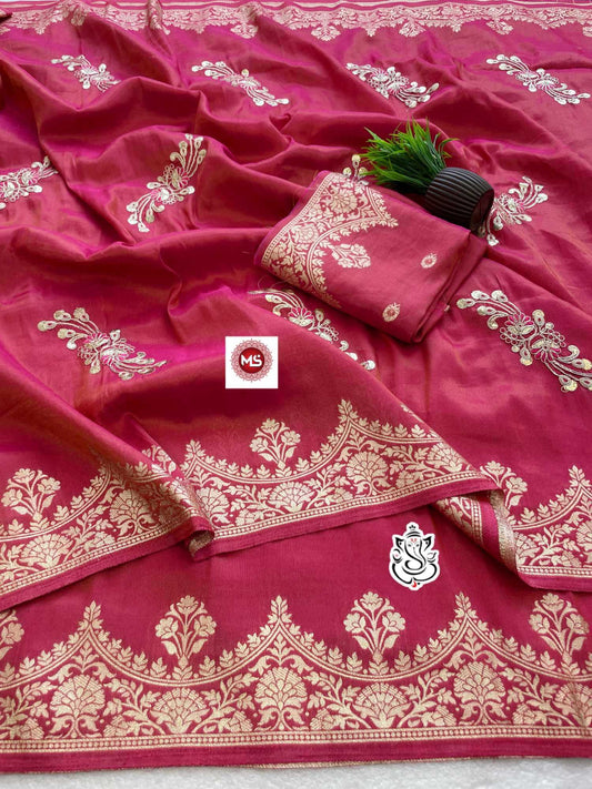 Pink saree with white embroidery and a brand logo in the center.