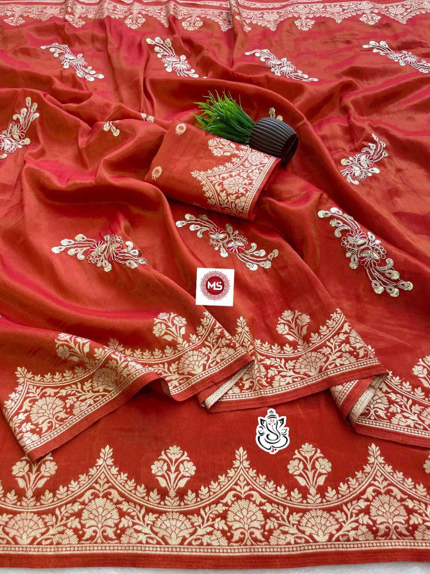 Red fabric with white embroidery and a visible brand logo on a white background