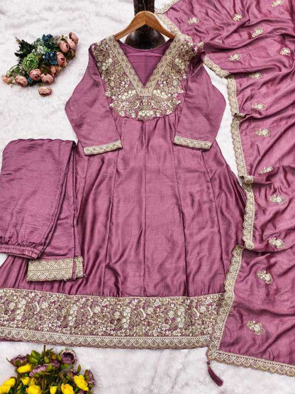 Purple traditional outfit with intricate silver embroidery on a white background