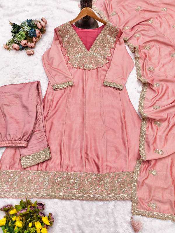 Pink traditional outfit with gold embroidery on a white background