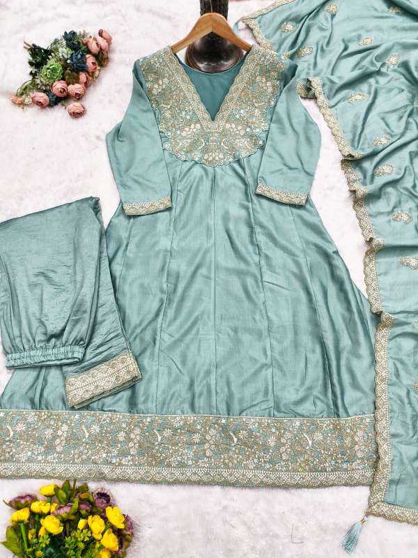 Teal embroidered traditional outfit with floral decorations on a white background