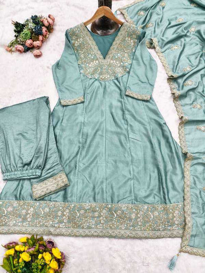 Teal embroidered traditional outfit with floral decorations on a white background
