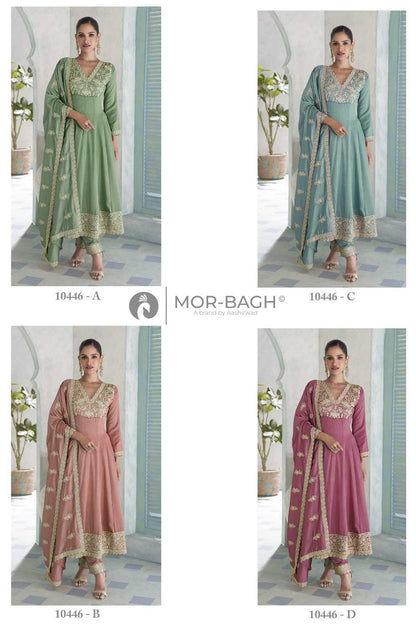 Four women modeling traditional Indian salwar kameez sets in a 2x2 grid. The sets are in sage green, light blue, dusty pink, and magenta, all featuring gold embroidered borders and matching dupattas.