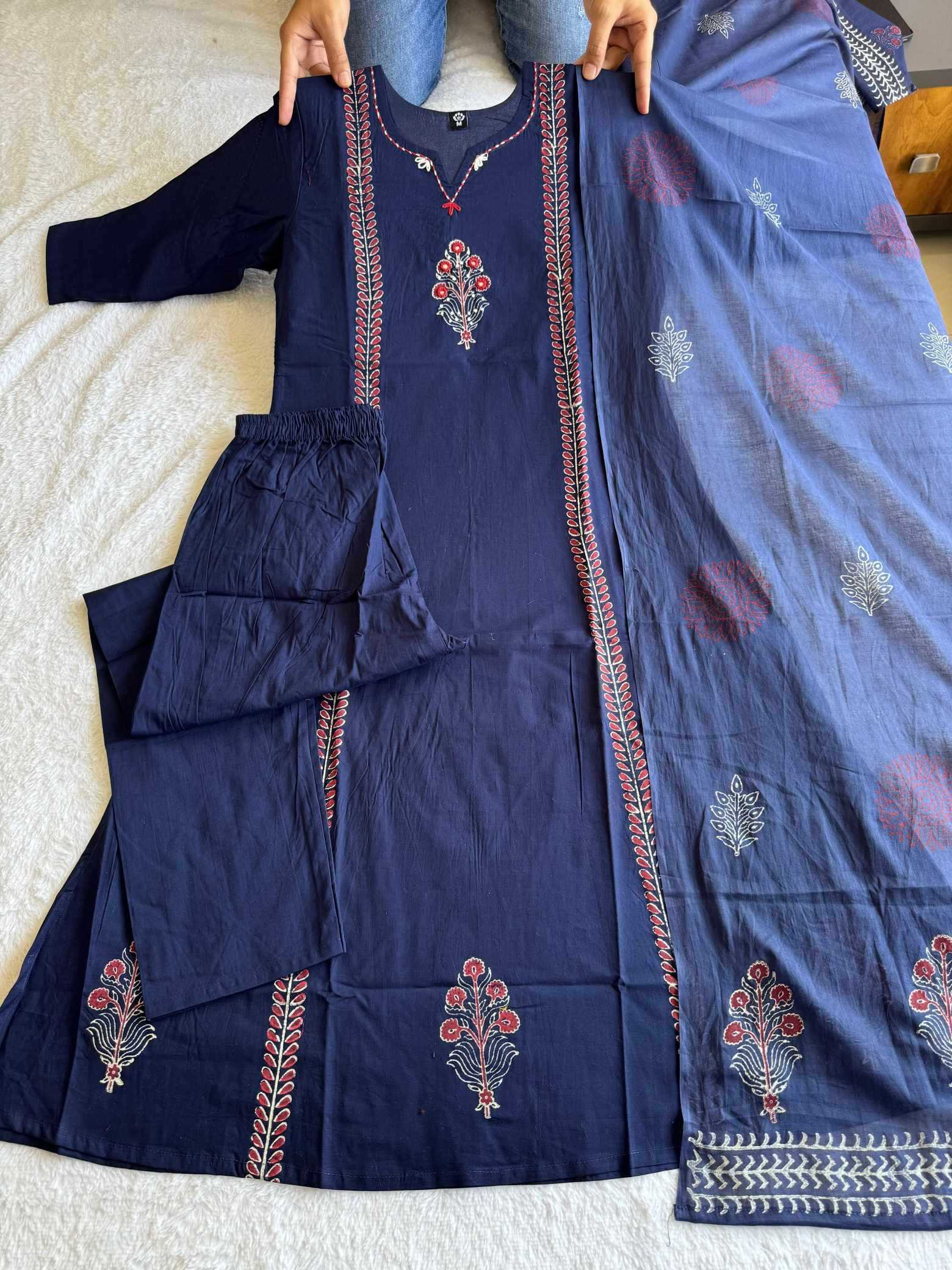 Navy blue embroidered traditional outfit with a dupatta on a white surface