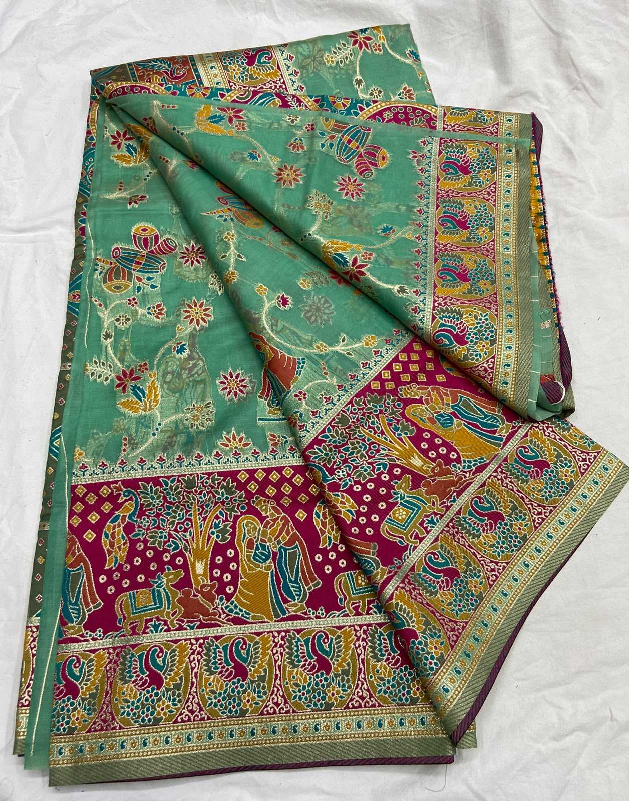 Colorful traditional fabric with intricate patterns on a white background