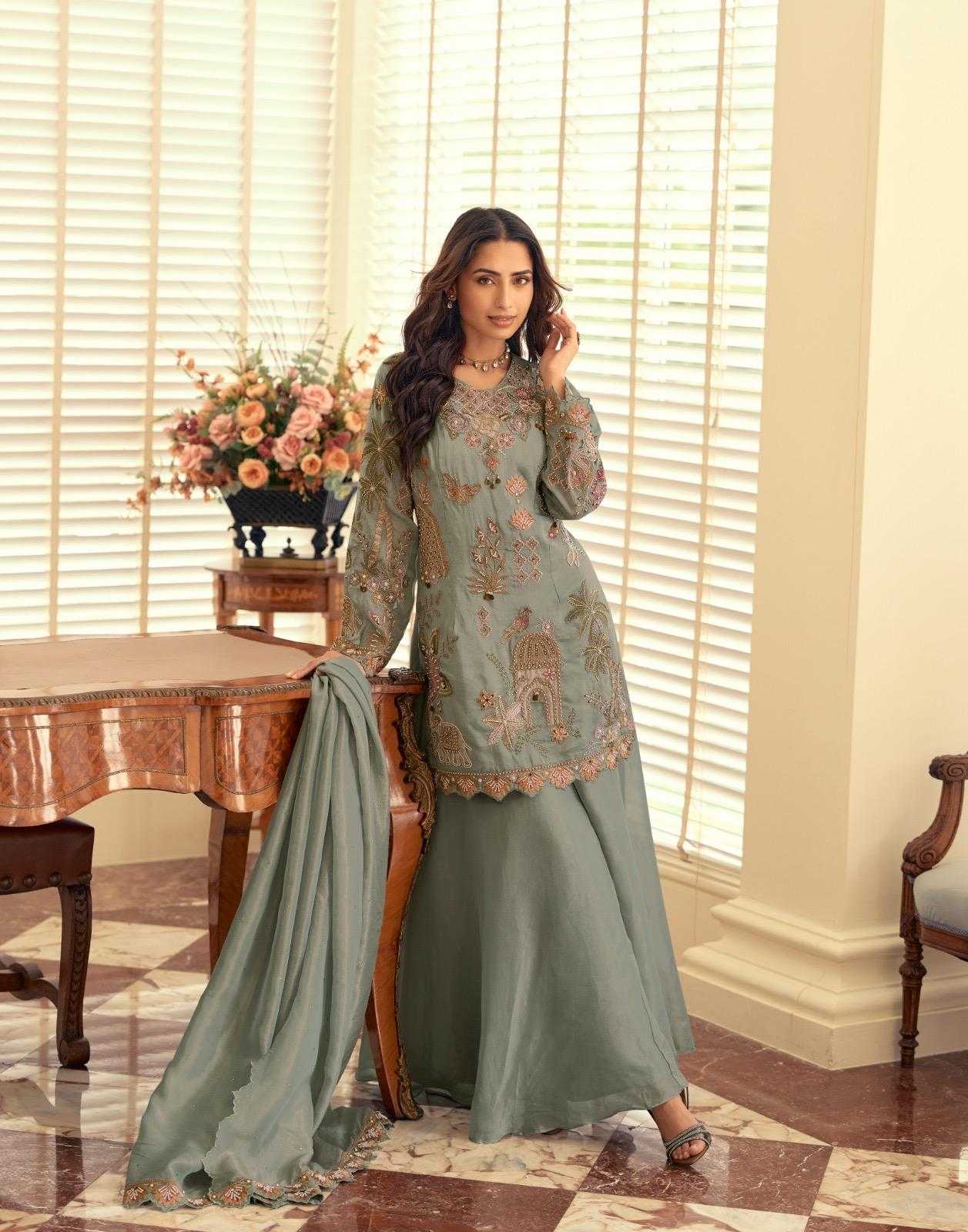 Woman in a traditional outfit standing in a room with a table and flowers.