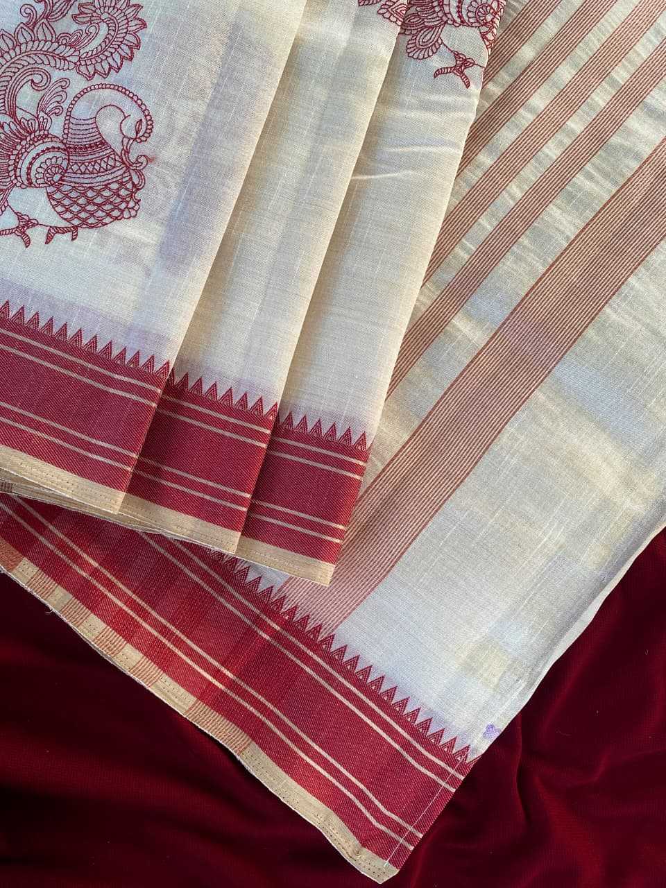 Red and white saree with intricate patterns on a dark background