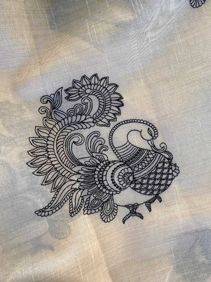 Decorative black peacock design on beige fabric