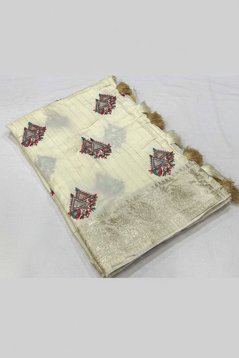 A cream-colored georgette saree with a wide zari border and embroidered motifs, displayed on a white background with text detailing the specifications.