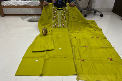 Green embroidered traditional outfit on a hanger with size label M to 3xl.