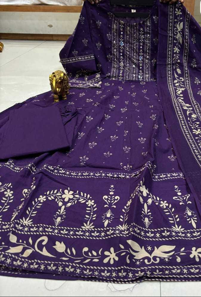 Purple traditional outfit with white patterns on a white floor.