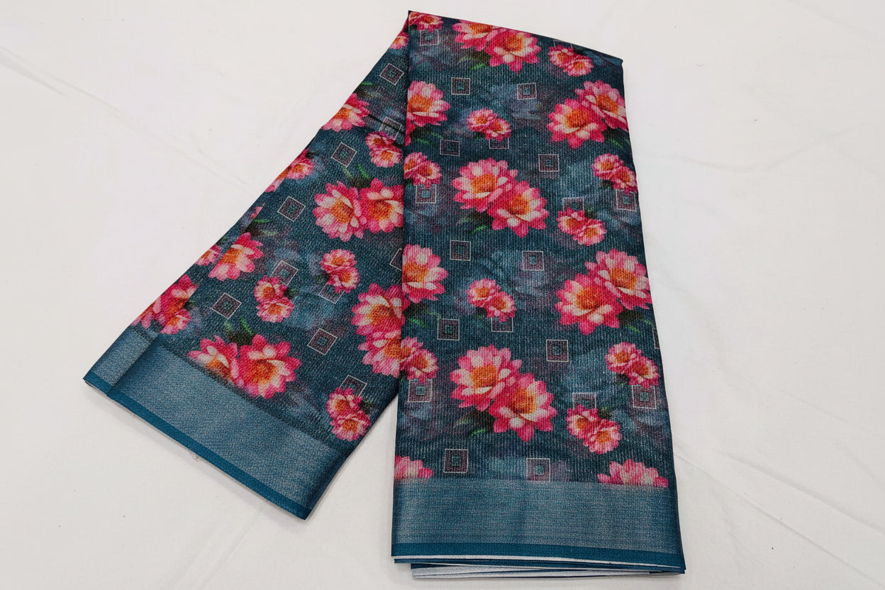 Floral patterned fabric with pink flowers on a dark blue background, displayed on a white surface.