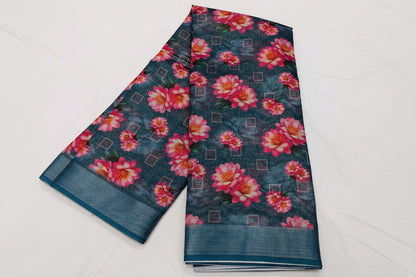 Floral patterned fabric with pink flowers on a dark blue background, displayed on a white surface.