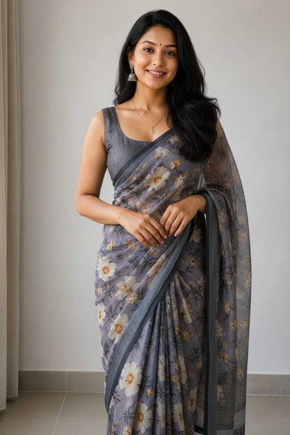 Woman wearing a floral saree taking a mirror selfie.
