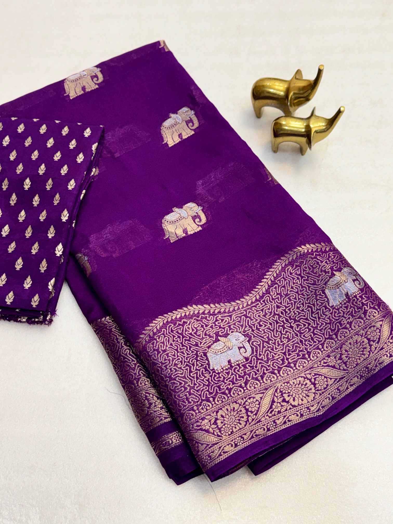 Purple saree with elephant patterns on a white background