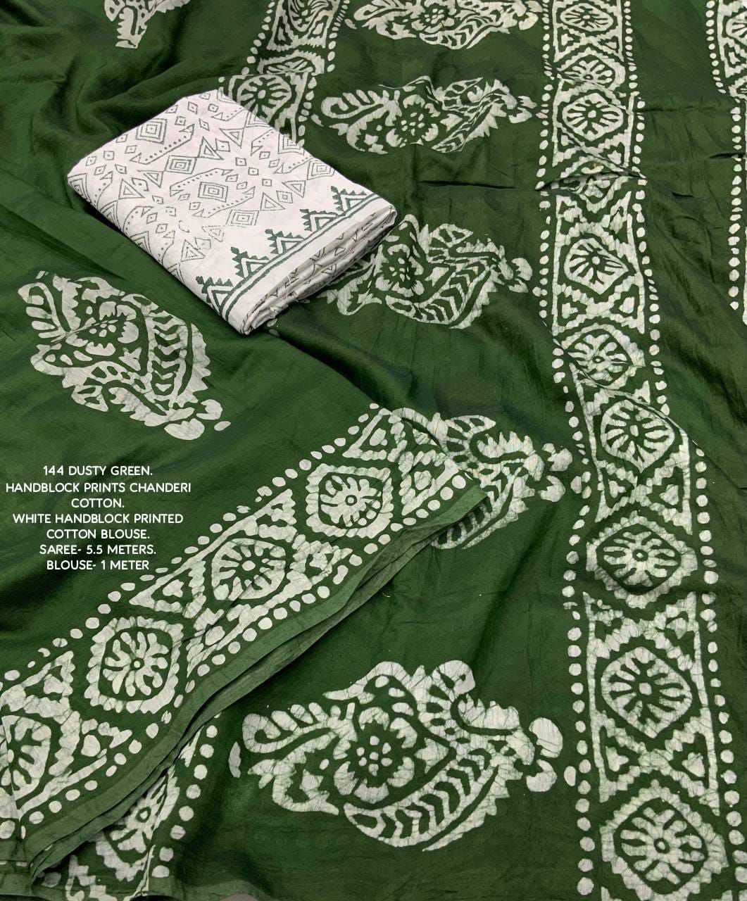 Green fabric with white pattern and folded white fabric on top