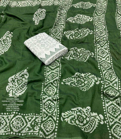 Green fabric with white pattern and a folded white cloth on top