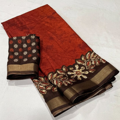 Red and brown saree with floral patterns on a white background