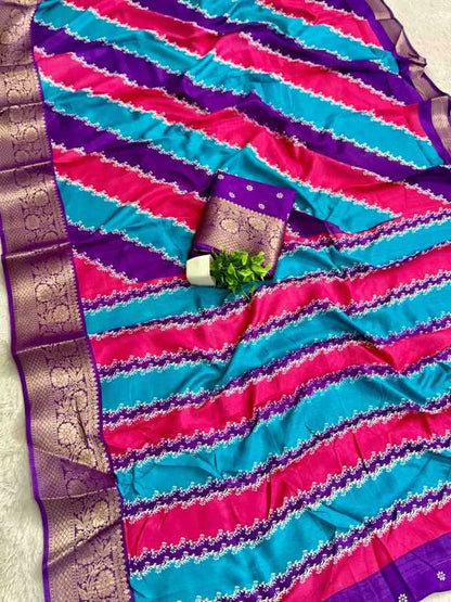 A vibrant pink and turquoise striped saree with purple borders and gold zari detailing, styled with a matching purple and gold border and a small green leaf sprig.