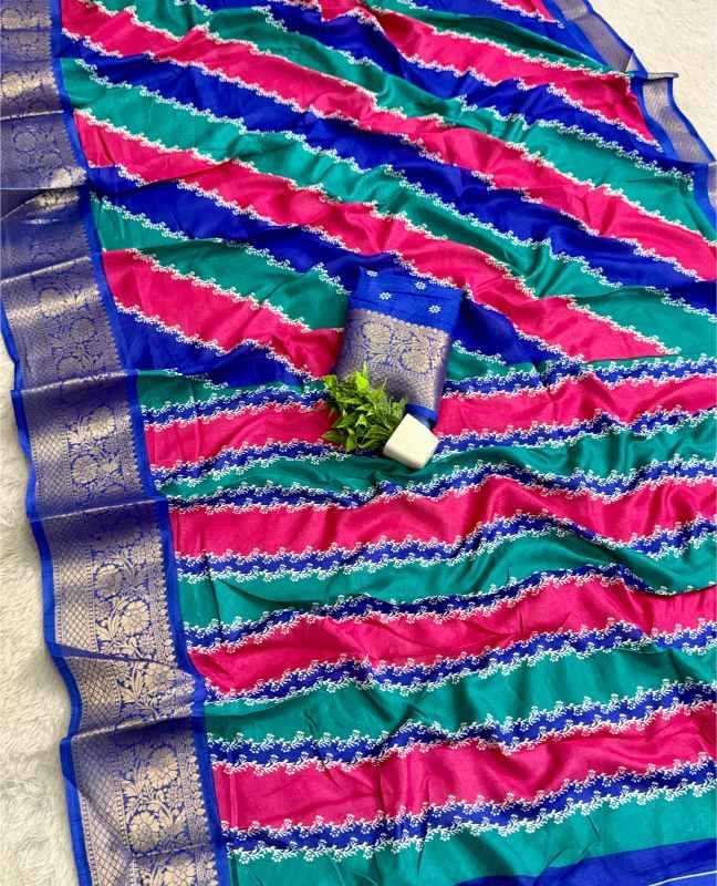 A vibrant pink and teal striped silk saree with a wide blue and gold zari border, styled with a matching blue blouse piece and a small green plant on a light textured surface.