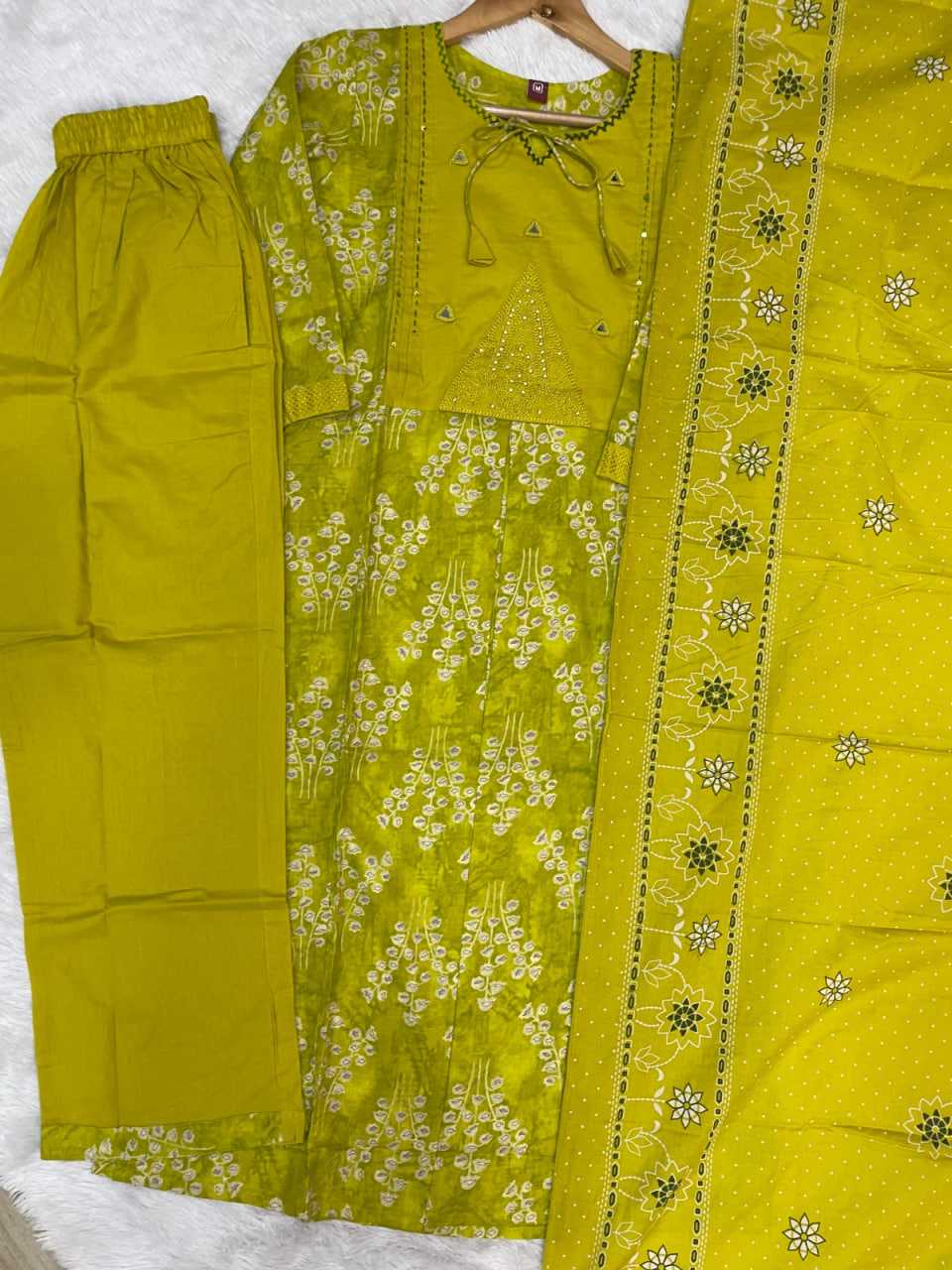 Green traditional outfit with floral patterns on a white background