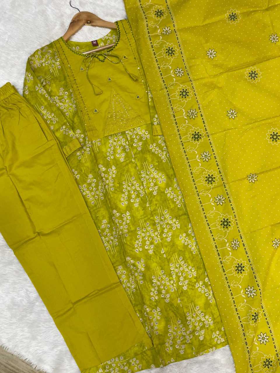 Yellow traditional outfit with floral patterns on a white background