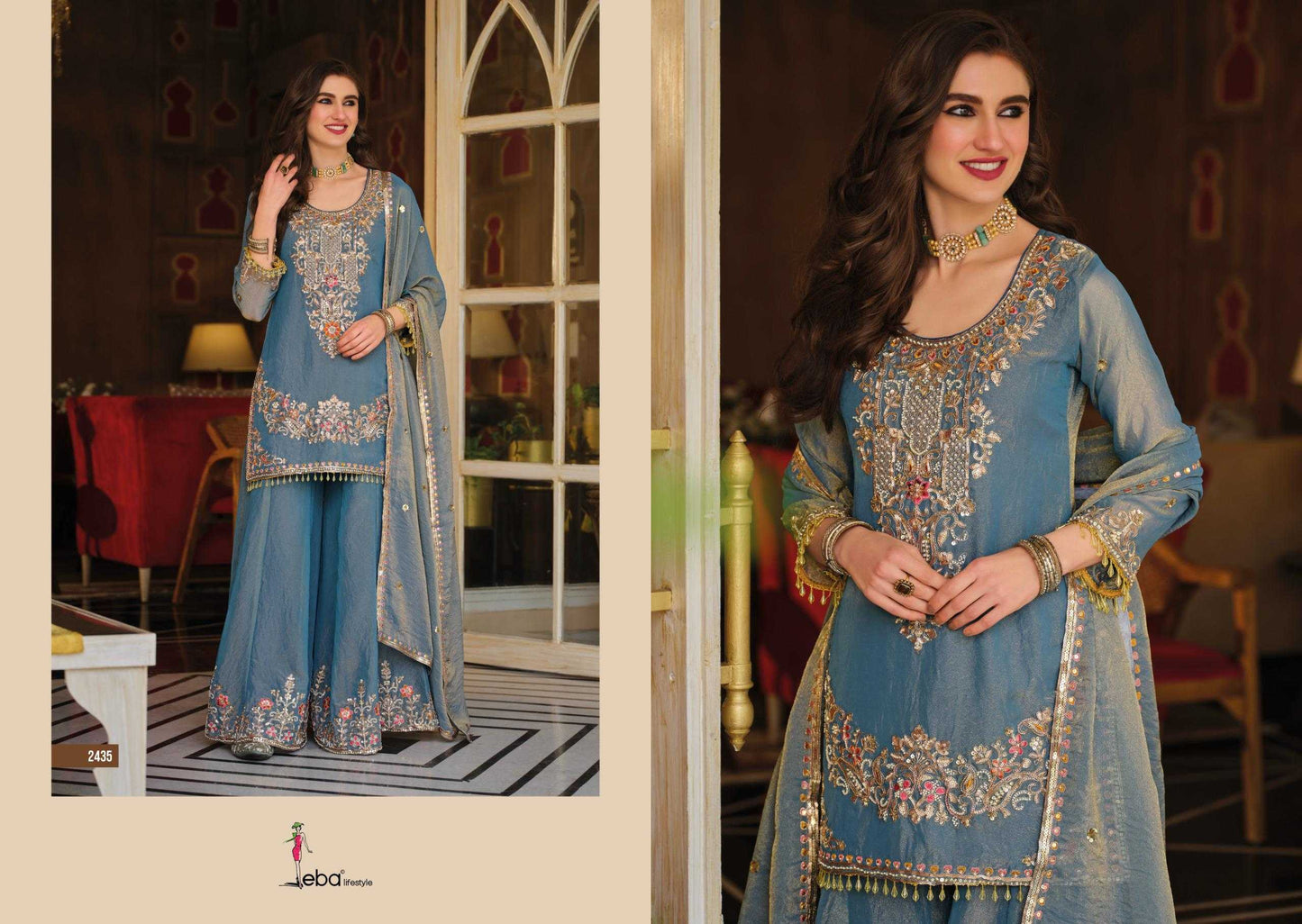 Woman in a blue embroidered traditional outfit standing in a decorated room.