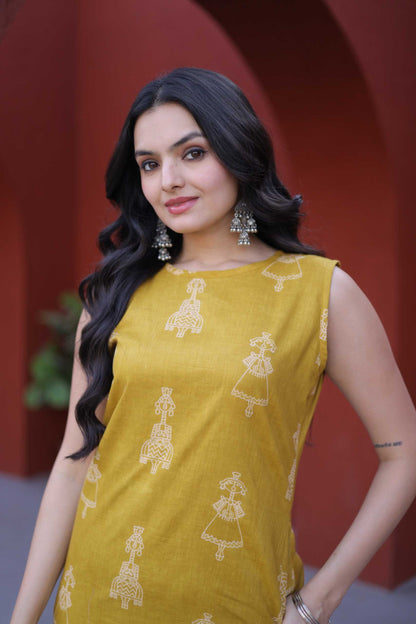Woman wearing a yellow sleeveless top with white patterns against a red background